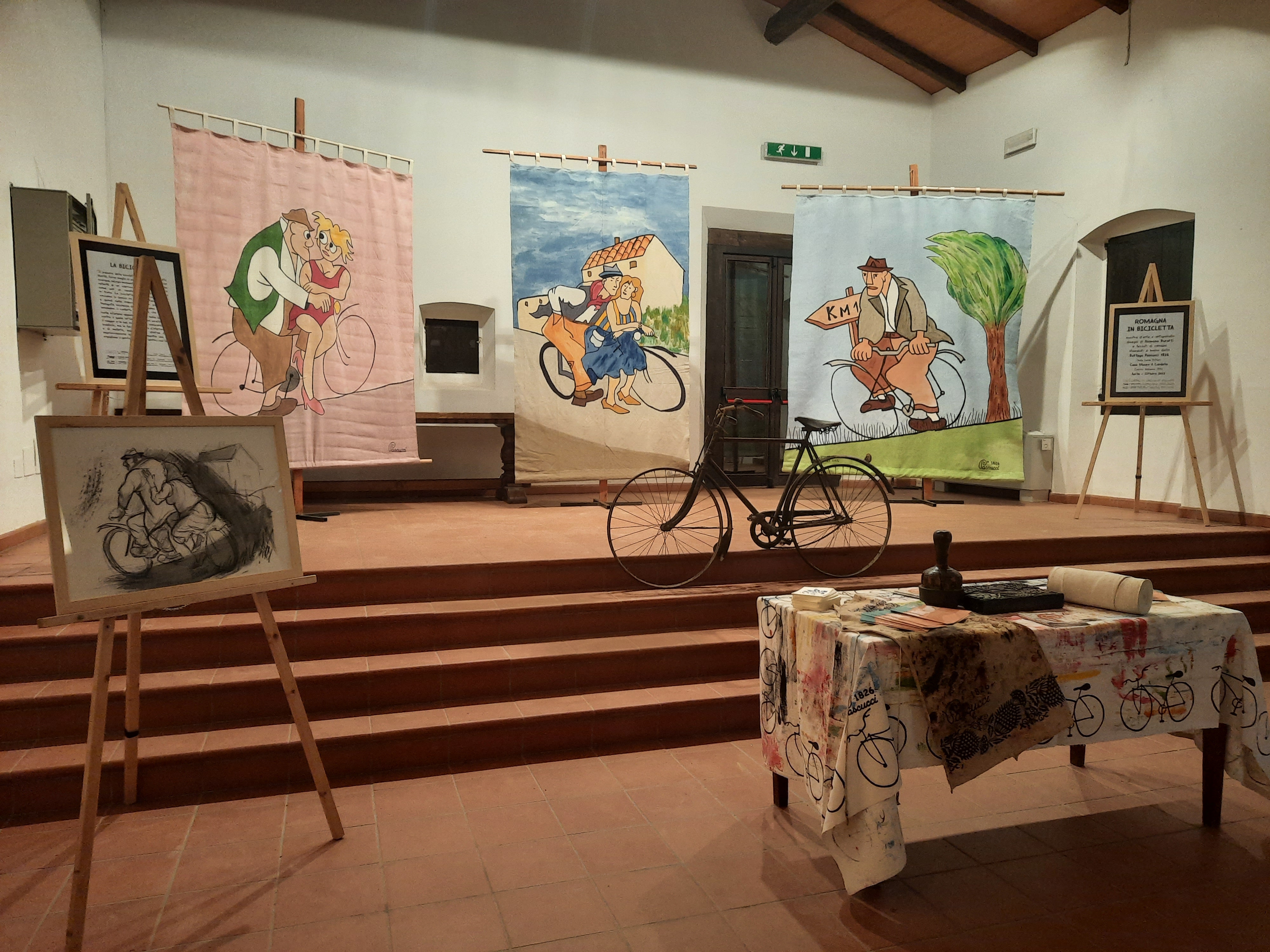  picture of the event: Al Cardello, per tutta l'estate, una mostra dedicata alla bicicletta, con disegni di Romano Buratti ed arazzi della Bottega Pascucci